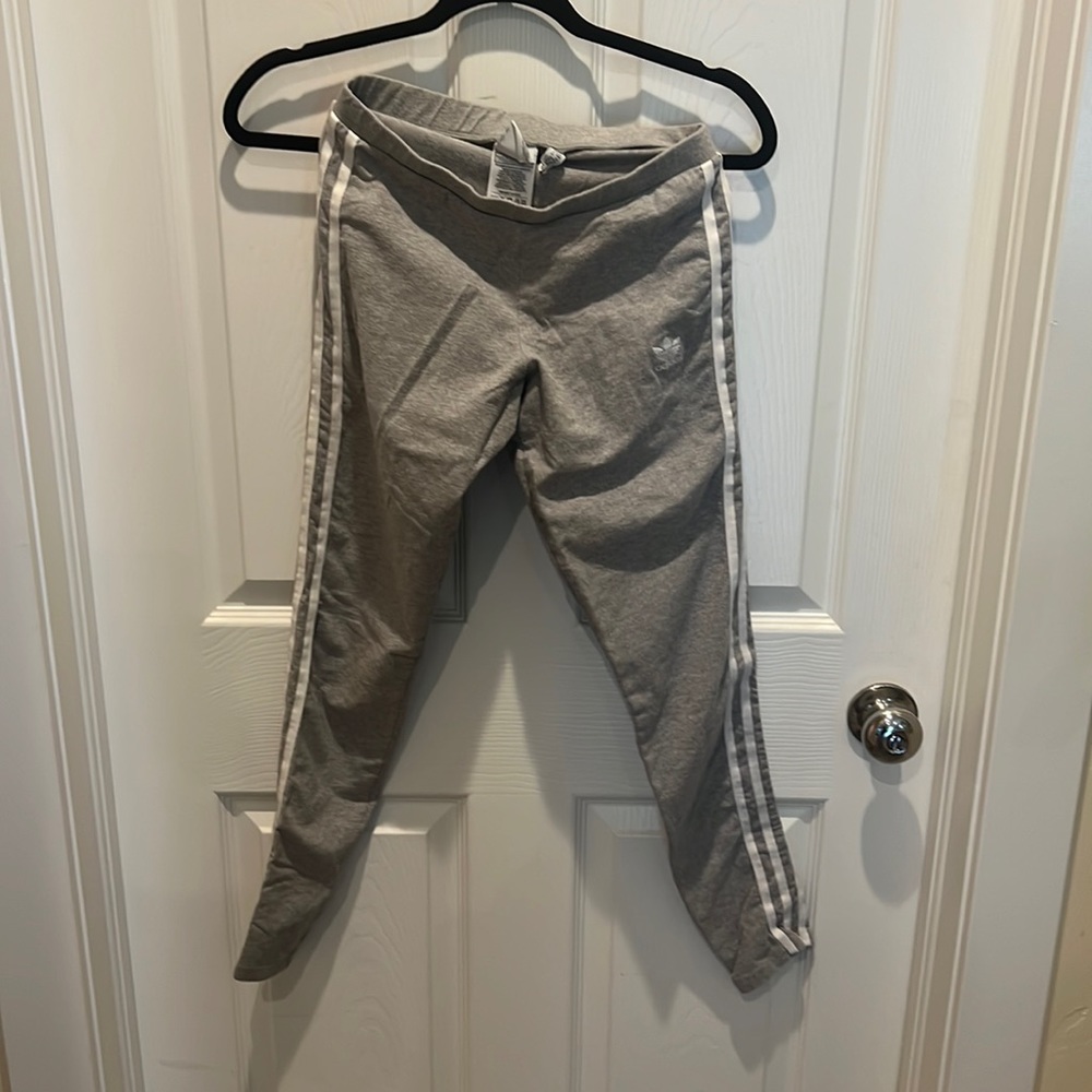 Small Grey Addidas leggings with white stripes.